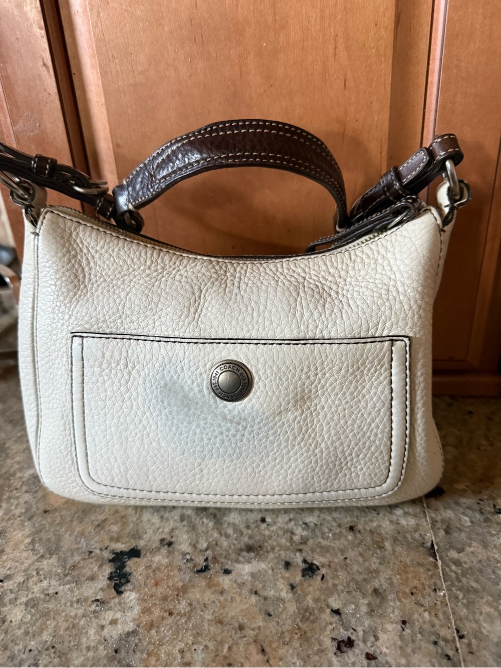 Coach Cream Pebbled Leather Mini Shoulder Bag slight discolored on front.